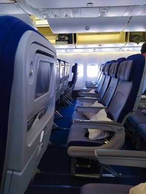 Frankfurt am Main, Germany - May 09, 2022: The blue screens display on airplane seat monitor and interior of Boeing 747 by Lufthansa before the flight
