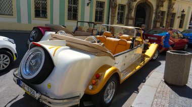 Prague, Czech Republic - May 11, 2022: An old style red car on the Prague streets.