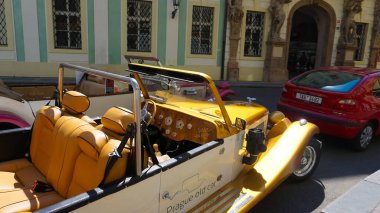 Prague, Czech Republic - May 11, 2022: An old style red car on the Prague streets.