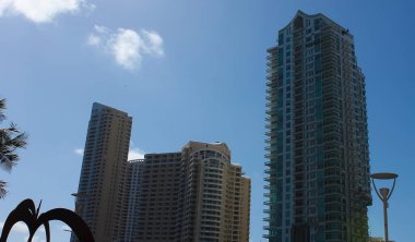 Miami, USA - April 23, 2022: Downtown Miami cityscape view with condos and office buildings against blue sky.