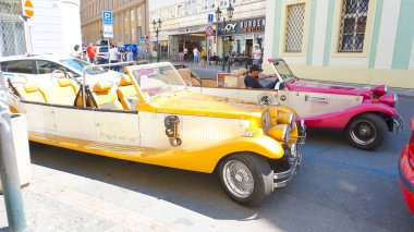 Prague, Czech Republic - May 11, 2022: An old style red car on the Prague streets.