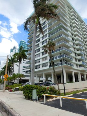 Miami, USA - April 24, 2022: Modern apartment buildings with palm trees at Avenue at Miami, Usa