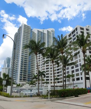 Miami, USA - April 24, 2022: Modern apartment buildings with palm trees at Avenue at Miami, Usa