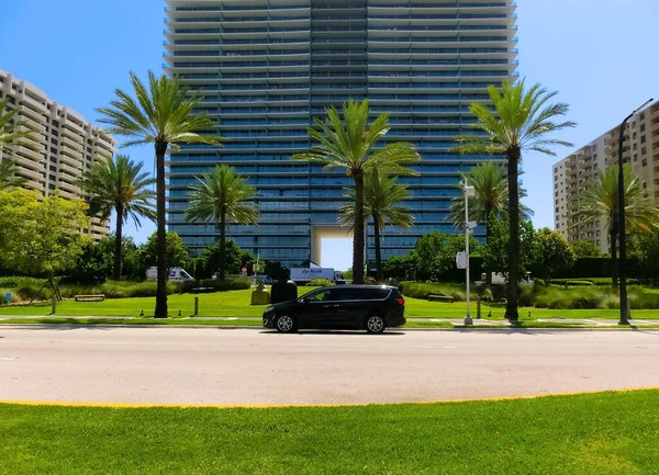 Miami, USA - April 24, 2022: Modern apartment buildings with palm trees at Avenue at Miami, Usa