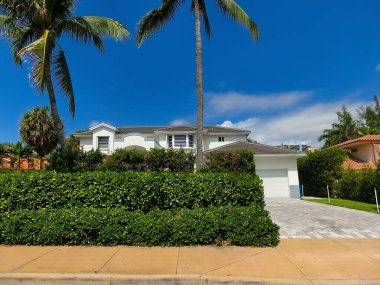 Modern apartment building or house with palm trees at Miami - view from road