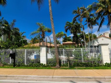 Modern apartment building or house with palm trees at Miami - view from road
