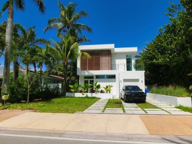 Modern apartment building or house with palm trees at Miami - view from road