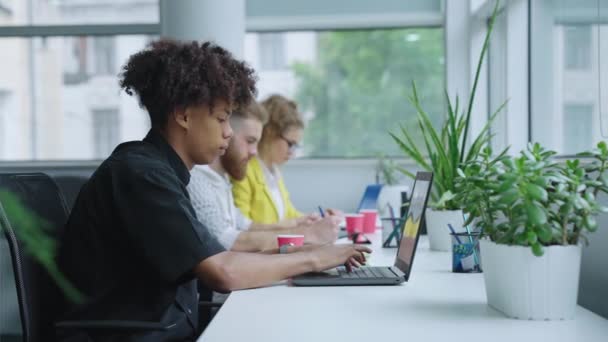 Afrikansk amerikansk kontorarbejder skriver på bærbar computer – Stock-video