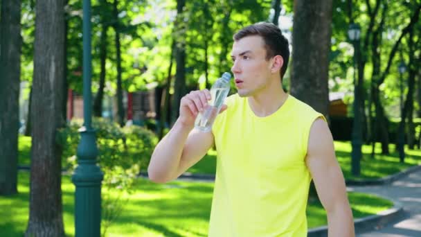 Jogger beber água depois de se exercitar no parque — Vídeo de Stock