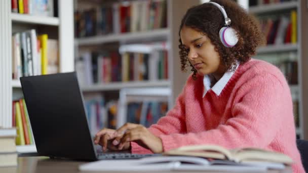 Menina negra navegando na internet para a tarefa de casa — Vídeo de Stock