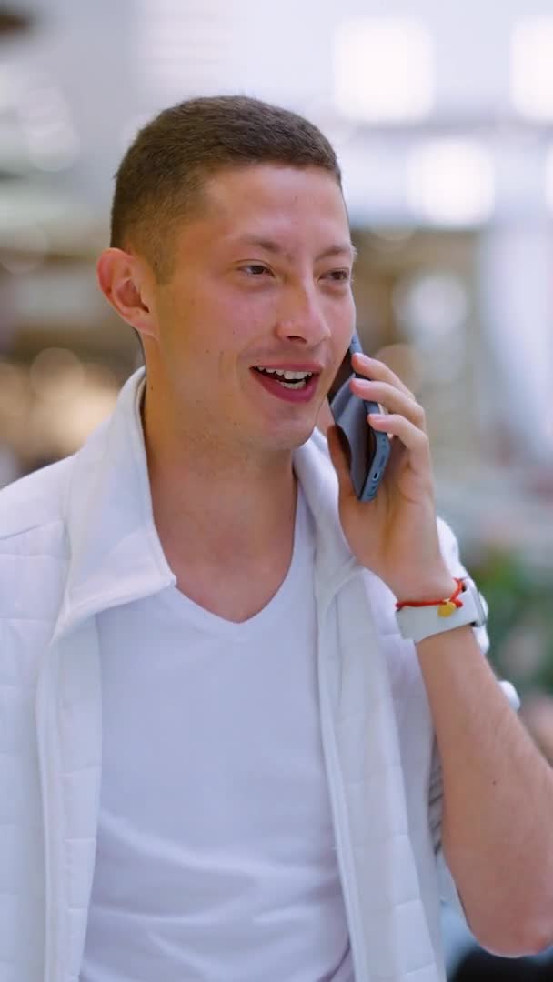 Schermo verticale: Giovane uomo che chatta al telefono sulla terrazza — Video Stock