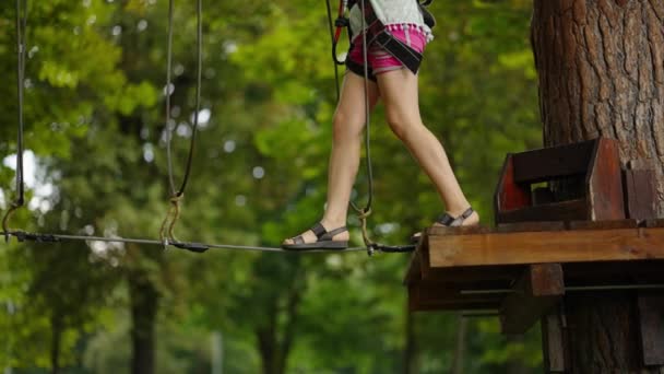 Девушка на канатной дорожке в тематическом парке — стоковое видео