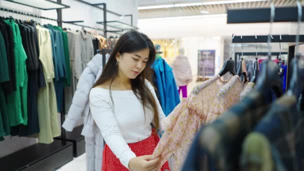 Woman trying on stylish dress at fashion store — Stock Video