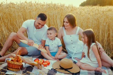 Babam tarladaki piknikte çocuklara ekmek veriyor.