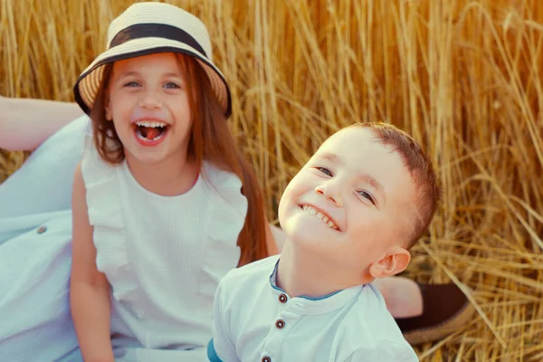 Kleine jongen lacht in het veld bij familie picknick Stockfoto