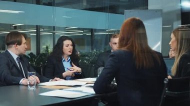 Bir grup iş adamı ofiste toplantı yapıyor.