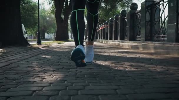 Närbild kvinnliga fötter som springer på trottoaren i slow motion — Stockvideo