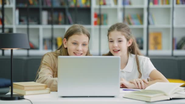 Female Pupils Wearing Uniform Sitting Desk Looking Laptop Browsing Internet — Stock Video