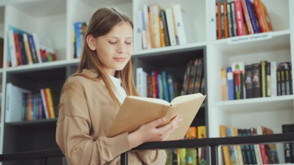 Kid Standing Bookshelves Laughing While Reading Funny Book Portrait School — Stock videók