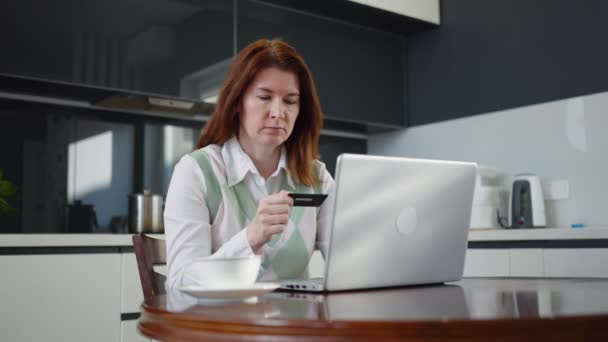Adult Female Disappointed While Ordering Online Credit Card Laptop Kitchen — Stock video