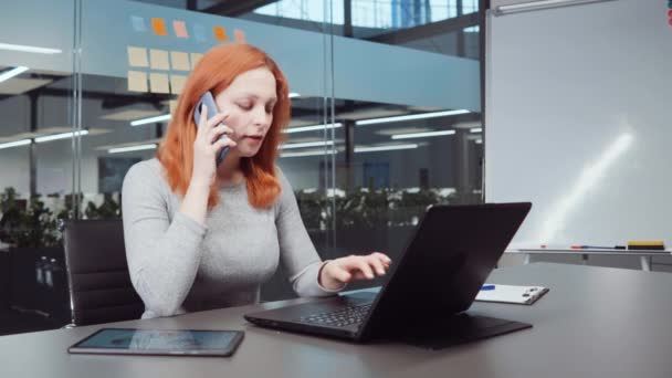 Roodharige Vrouw Zit Het Kantoor Praat Telefoon Met Behulp Van — Stockvideo