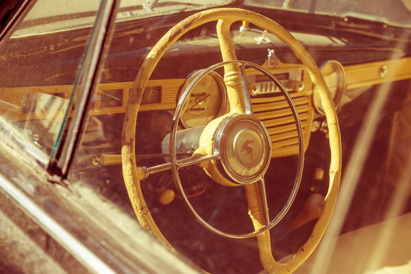 Retro car, steering wheel, vintage interior.