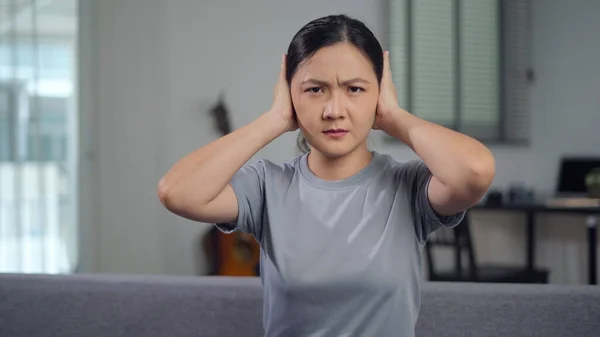 Asian Woman Bored Annoyed Covering Her Ears Sitting Sofa Living — Stock Fotó