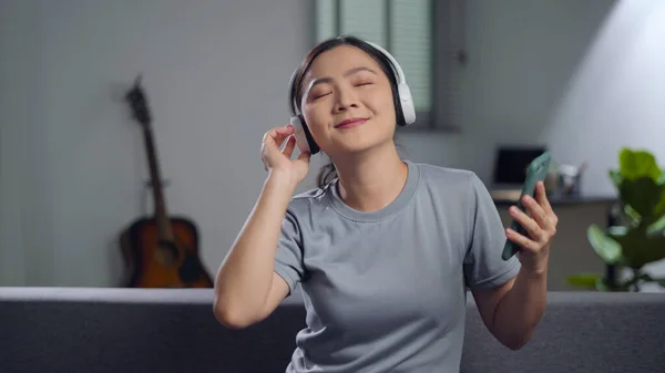 Happy Woman Using Smart Phone Headphones Listening Music Sitting Sofa — ストック写真