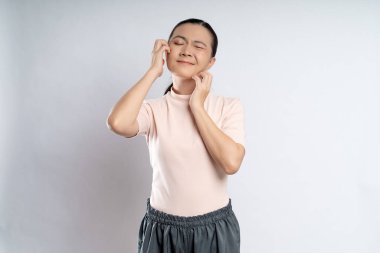 Asian woman was sick with irritate itching her skin, scratching her skin, standing isolated on white background.