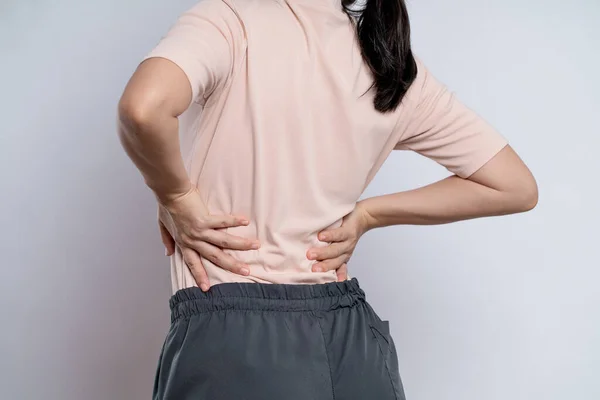 Asian woman was sick with body pain touching her body and standing isolated on white background.
