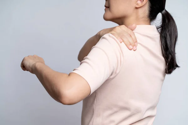 Asian woman was sick with body pain touching her body and standing isolated on white background.