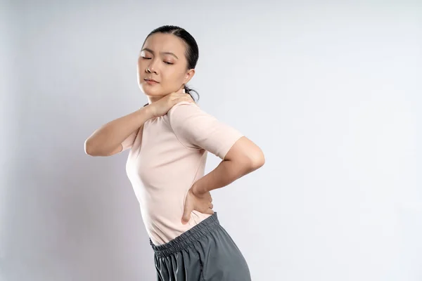 Asian woman was sick with body pain touching her body and standing isolated on white background.