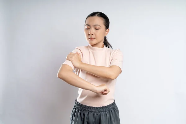 Asian woman was sick with body pain touching her body and standing isolated on white background.