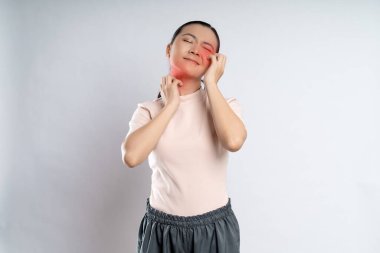 Asian woman was sick with irritate itching her skin, scratching her skin, with red spot standing isolated on white background.