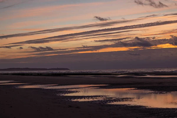 Dramatic sunset on the beach with beautiful colorful sky, Cap Blanc Nez, opal coast of France, Europe