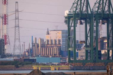 Antwerp, Belçika, Avrupa, 20 Nisan 2022, sisli bir akşamda bir sıra vinç Antwerp Limanı 'na girdi. Yüksek kalite fotoğraf