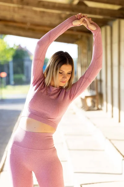 Beautiful Young Blonde Fitness Woman Wearing Pink Sports Clothes Stretching — Stock Photo, Image