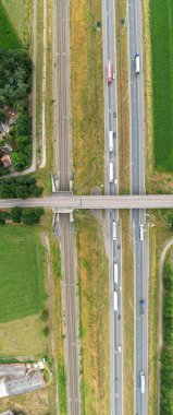 Aerial view of highway road junction. Highways, railroads, , bridge and green fields on the outskirts of the city. in Belgium Transport concept. High quality photo shot by a drone