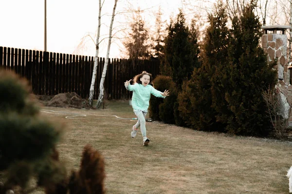 Little Screaming Girl Blue Jacket Runs Lawn Trees Her Arms — стоковое фото