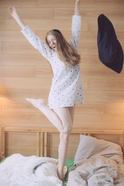 Happy Young Girl Red Hair White Pajamas Jumping Bed Throwing — 스톡 사진