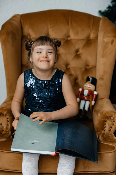 Curvy Little Girl Blue Dress Sits Brown Armchair Reading Magazine —  Fotos de Stock