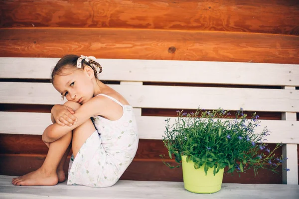 Little Girl Pigtails Summer White Dress Offended Sits Bench Hugging — Stock Photo, Image