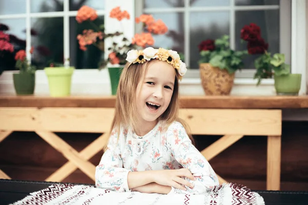 Little Smiling Girl Sits Table Backdrop Fresh Flowers Portrait Cute — Stock Photo, Image