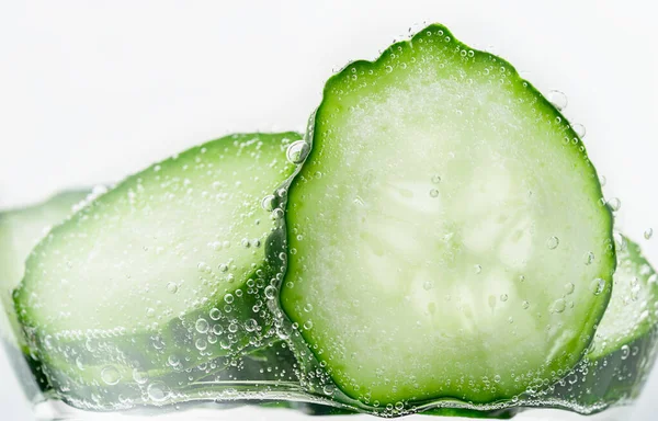 Close up of cucumber slices under water. — Stock Photo, Image