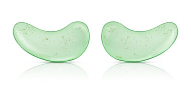 Green eye patches with aloe vera and tea tree leaves isolated on white background 