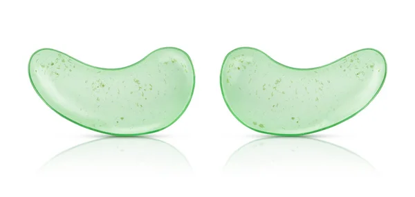 Green eye patches with aloe vera and tea tree leaves isolated on white background 