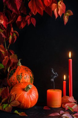 Halloween frame with pumpkins and burning candles on dark background. Mockup