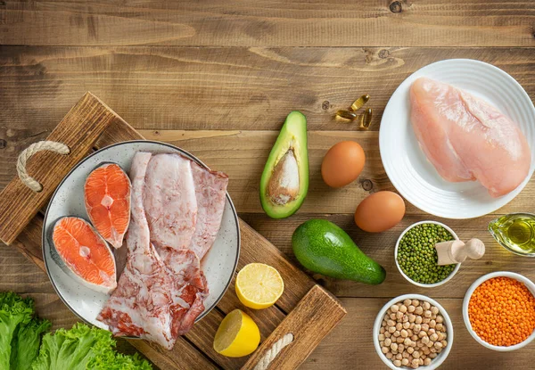 Table top view of ketogenic diet foods on wooden background. Top view