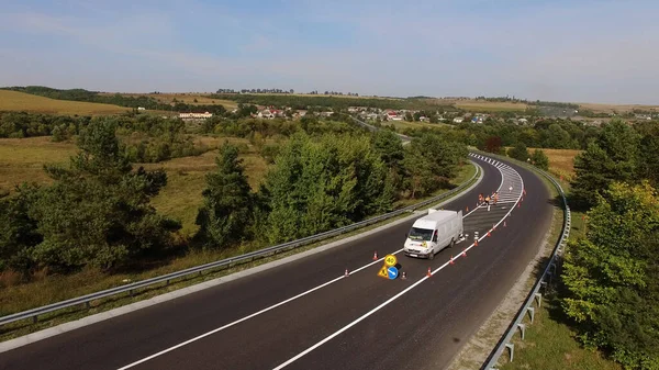 Road marking after road repair with workers. Aerial shot. High quality 4k footage