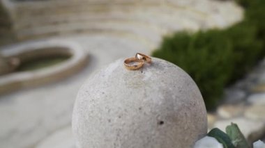 Wedding ring on stoneball. Rings on cement stone, around shot. High quality FullHD footage